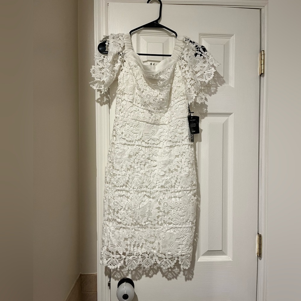 Lulus white lace dress. It is form fitting and hits just above knees.
